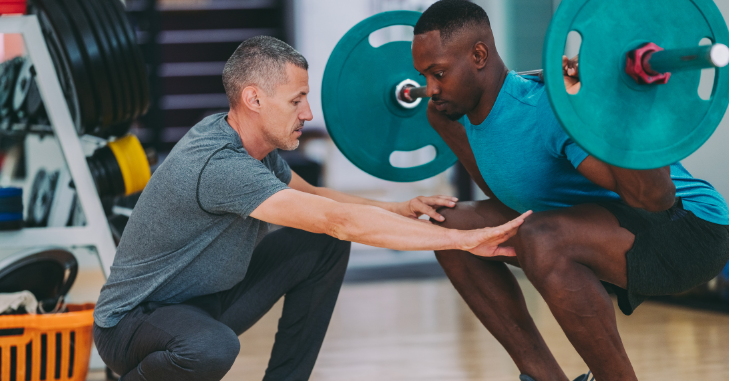 Personal trainer coaching a client through a workout