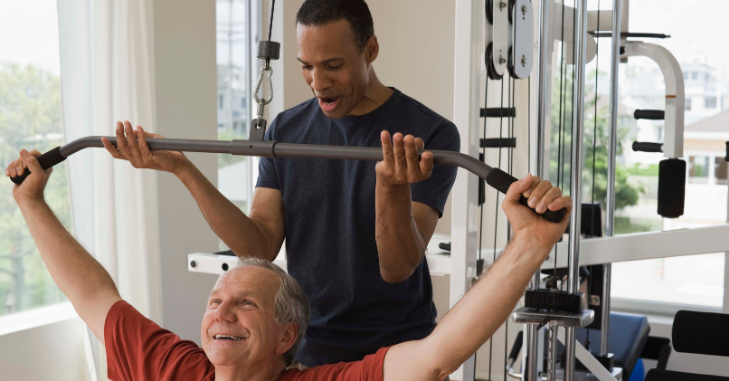 Trainer demonstrating an exercise in a gym